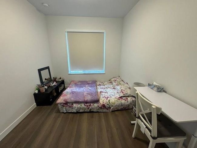 Bedroom featuring wood finished floors and baseboards | Image 12