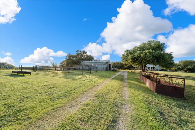 View of yard featuring a view of countryside, an outdoor structure, and an exterior structure | Image 35