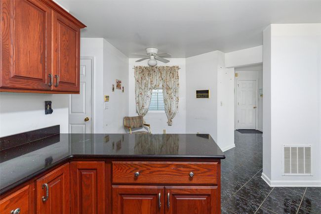 Kitchen with ceiling fan, breakfast nook and dark tile flooring | Image 11