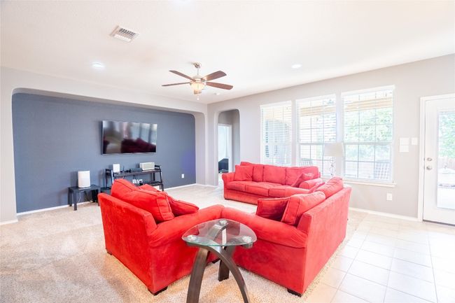 Living area featuring arched walkways, a ceiling fan, and recessed lighting | Image 7