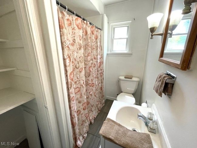 Full bathroom featuring vanity, toilet, wood finished floors, and a shower with curtain | Image 19