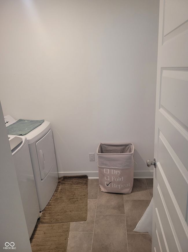 washroom featuring washing machine and clothes dryer and tile patterned floors | Image 16
