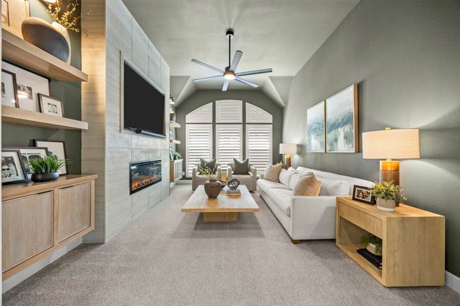 Carpeted living room featuring a fireplace, a ceiling fan, and vaulted ceiling | Image 13