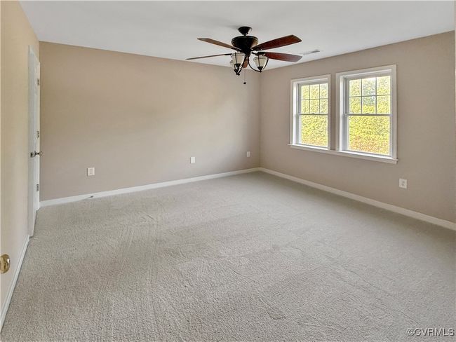 Carpeted empty room with ceiling fan and baseboards | Image 13
