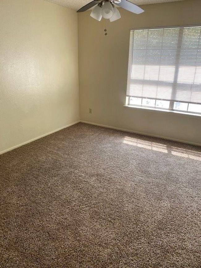 Unfurnished room with baseboards, ceiling fan, and carpet flooring | Image 8