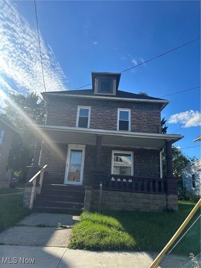 View of front of home featuring a front yard and a porch | Image 1