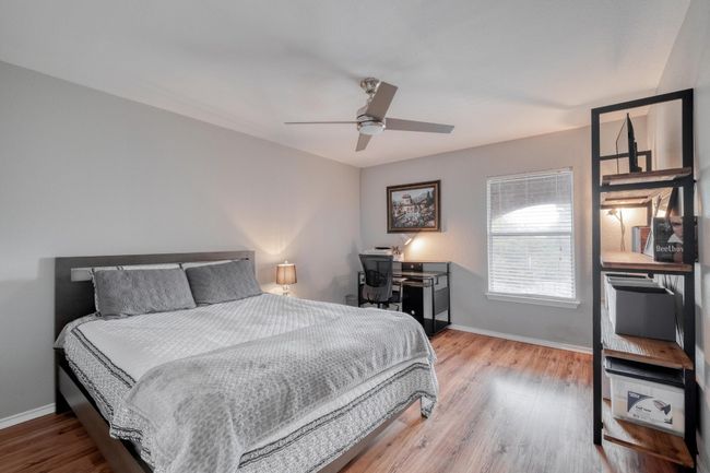 Bedroom with wood finished floors and ceiling fan | Image 27