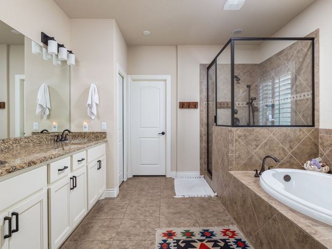 Master bath showing door to generous sized closet. | Image 17