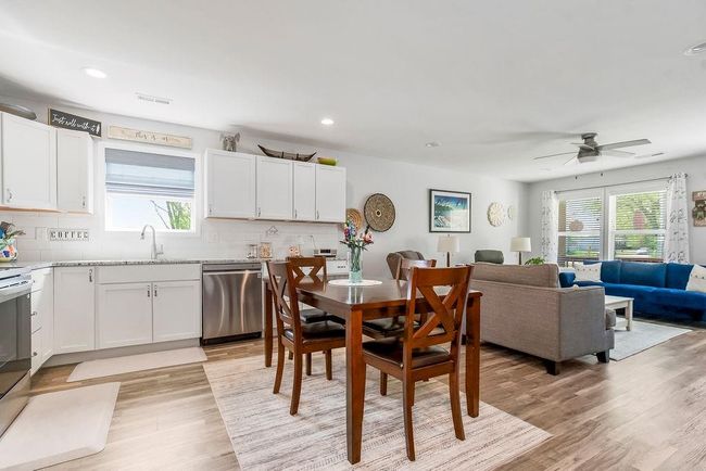 Dining space with ceiling fan, a healthy amount of sunlight, and light wood-style flooring | Image 14
