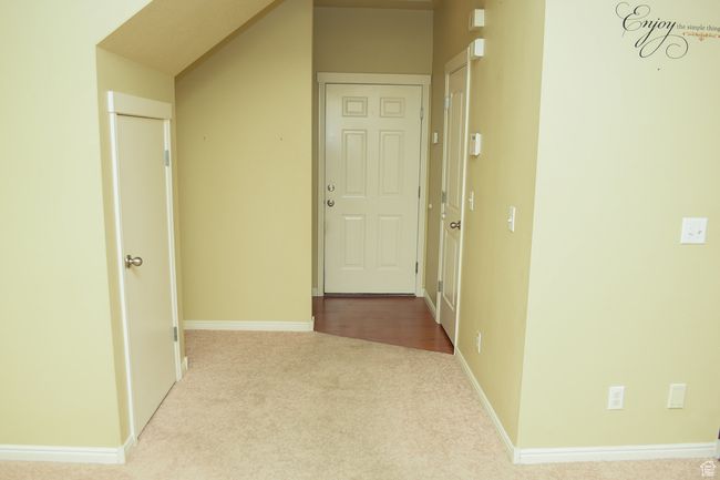 Hallway with carpet floors and baseboards | Image 6