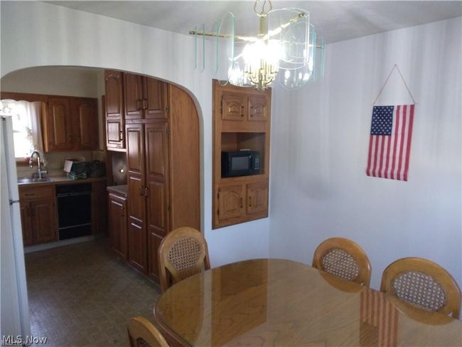 Dining room with sink and a chandelier | Image 5