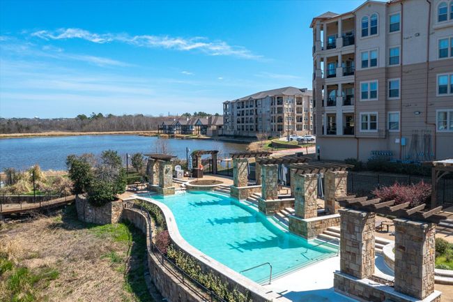 Community pool with a water view, a jacuzzi, and a pergola | Image 40