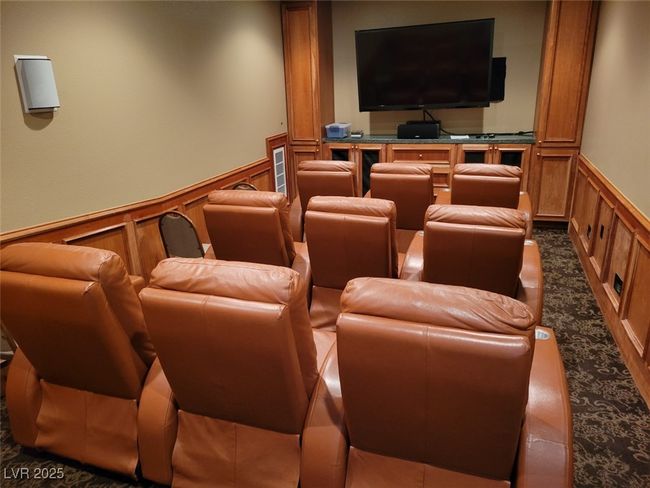 Home theater room with carpet floors, a decorative wall, and a wainscoted wall | Image 15