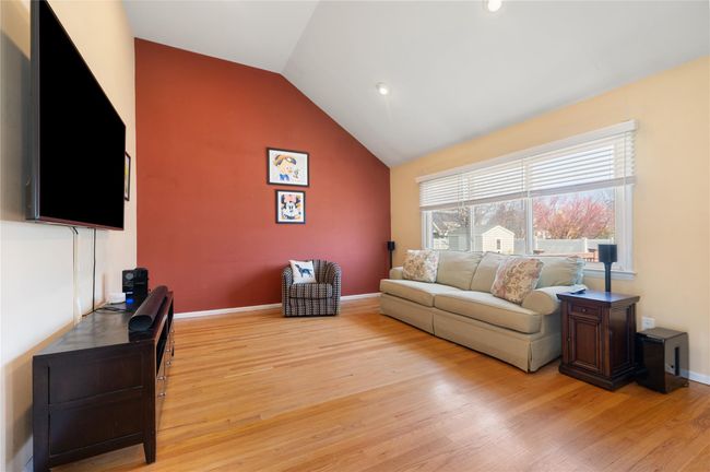 Living area featuring baseboards, lofted ceiling, and light wood finished floors | Image 8