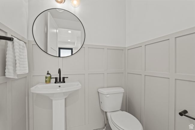 Half bathroom featuring a decorative wall and a wainscoted wall | Image 28