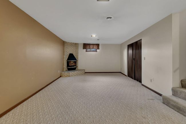 Huge Finished Lower Level Family Room with wet bar area and electric fireplace | Image 22