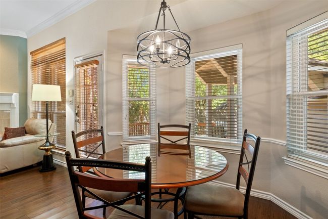 Dining room featuring a chandelier, wood finished floors, baseboards, and ornamental molding | Image 17