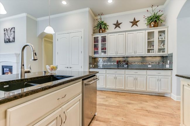View of glass cabinets and large pantry. | Image 5