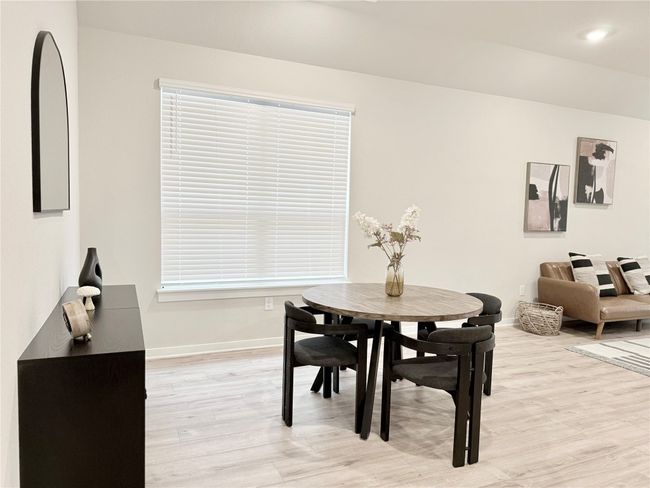 Dining area featuring light wood finished floors and baseboards | Image 11