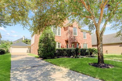 A 2-CAR DETACHED GARAGE IS TUCKED DISCREETLY ON THE SIDE OF THE HOME. | Image 2