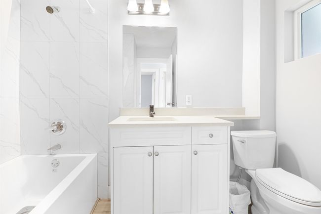Bathroom with bathtub / shower combination, toilet, and vanity | Image 17