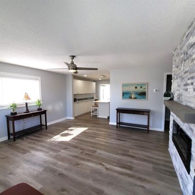 Step into the 14X15 Living Room and notice the beautiful luxury plank flooring and neutral wall colors. | Image 2