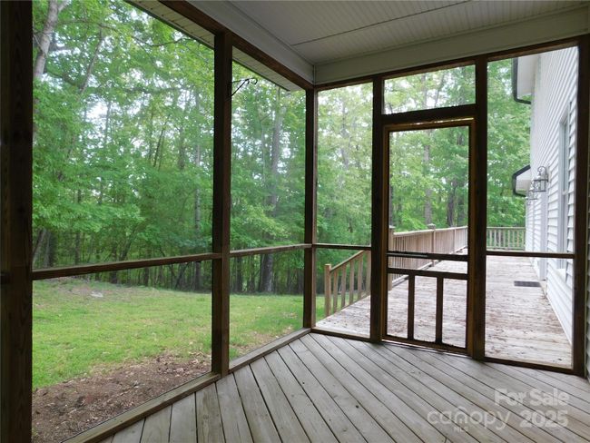 Screened-in porch leads to the open deck. | Image 16