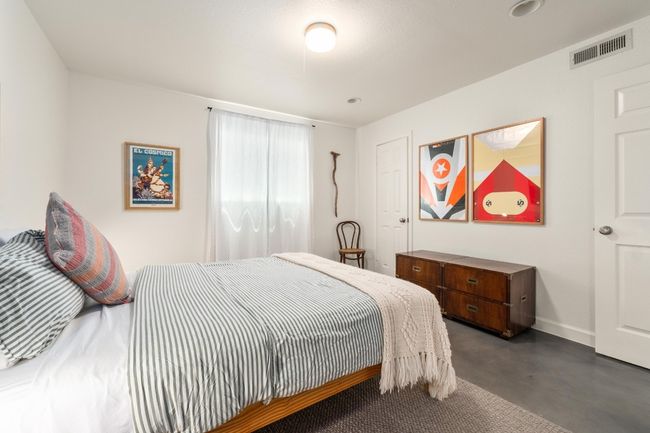 Bedroom featuring finished concrete floors and baseboards | Image 13