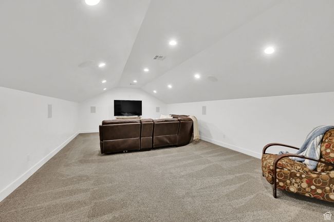 Carpeted home theater with lofted ceiling and recessed lighting | Image 34
