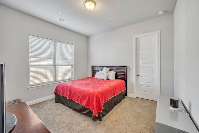 Bedroom featuring light colored carpet and multiple windows | Image 19
