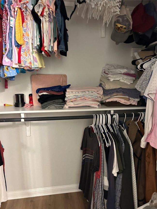 Spacious closet with wood finished floors | Image 19