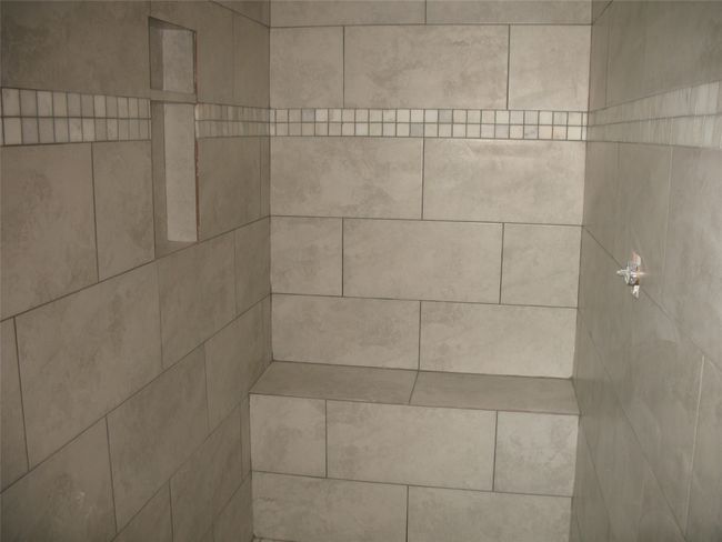 Bathroom view of a tile shower | Image 12