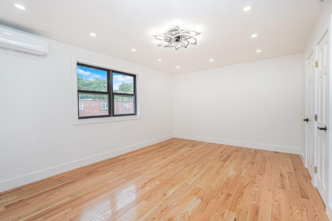 Spare room featuring a wall mounted AC, recessed lighting, and light wood-type flooring | Image 7