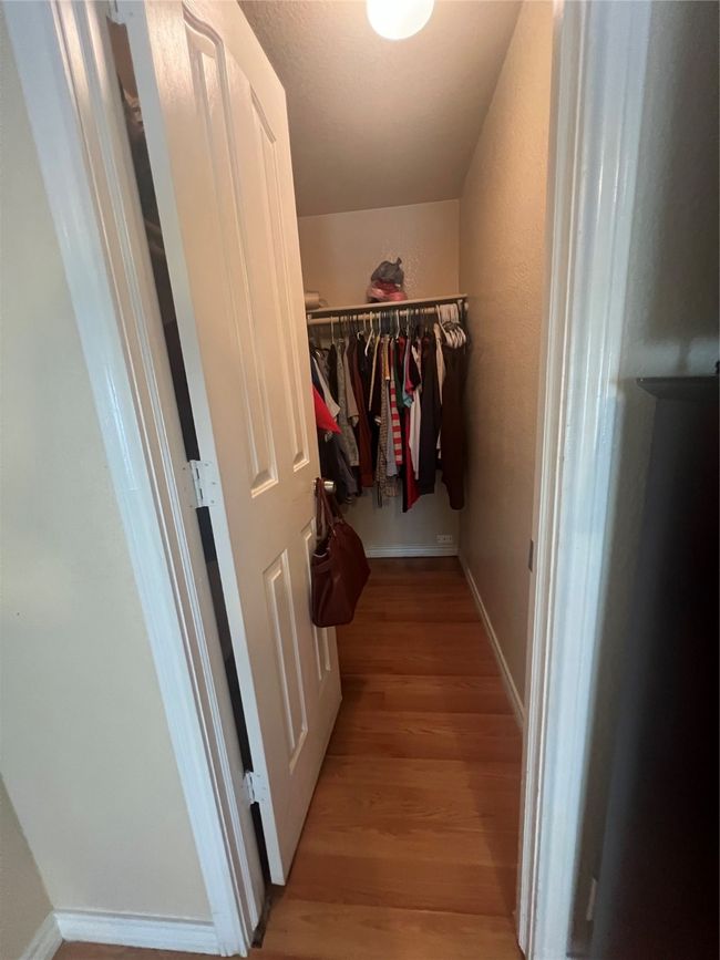 Walk in closet with light wood finished floors | Image 14