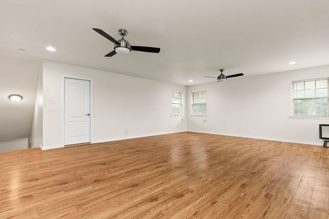 Unfurnished room featuring a ceiling fan, plenty of natural light, and recessed lighting | Image 32