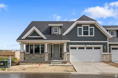 Craftsman-style home featuring a garage and a porch | Image 1