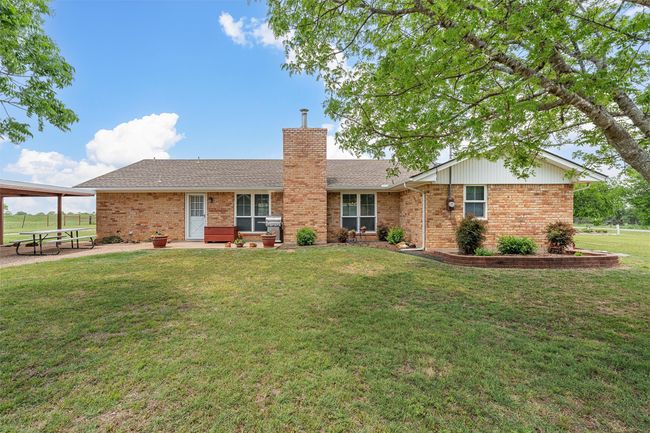 Single story home featuring brick siding, a front yard, a chimney, and roof with shingles | Image 26