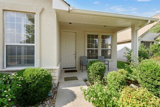 Property entrance with stucco siding and covered porch | Image 4