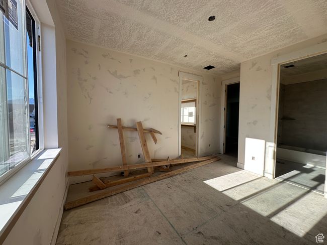 Unfurnished bedroom featuring a textured ceiling | Image 22