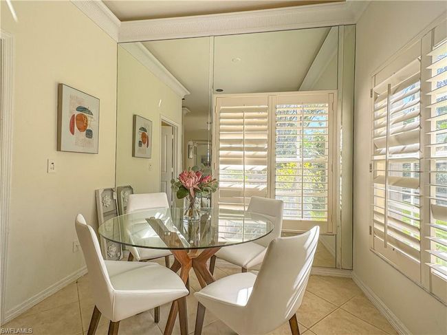 Dining area featuring vaulted ceiling and light tile floors | Image 37