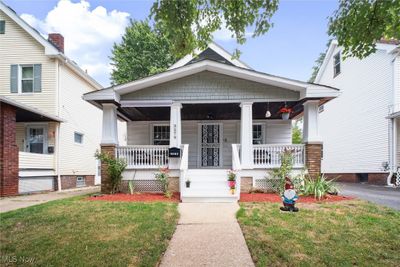 Bungalow-style house with a front yard and covered porch | Image 1