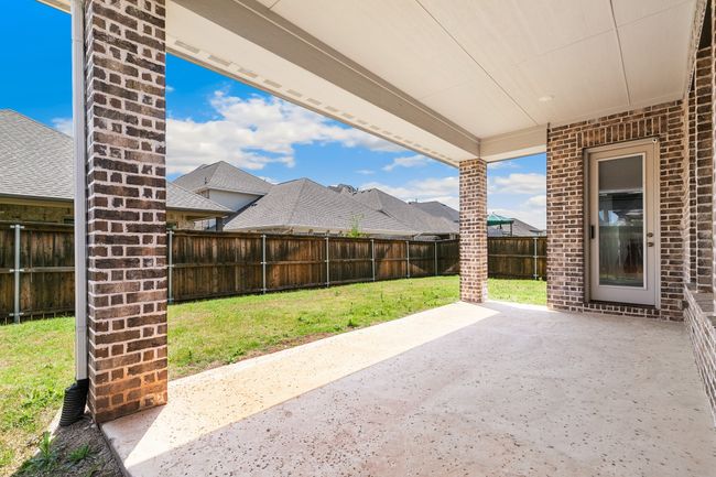 View of patio with a fenced backyard | Image 29