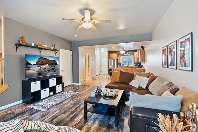 Living room with ceiling fan and wood finished floors | Image 4