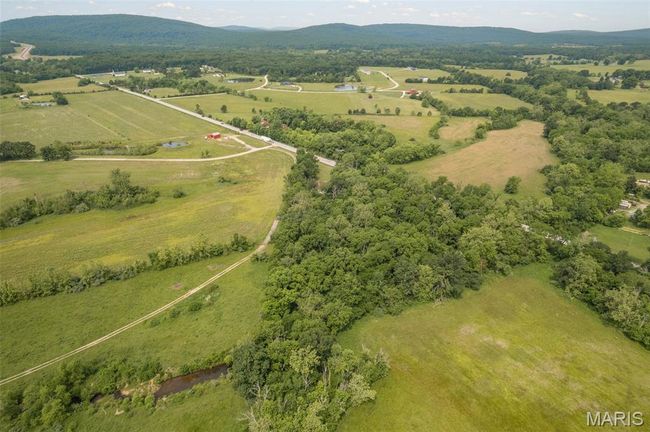 Aerial overview of property's location featuring rural landscape and mountains | Image 48