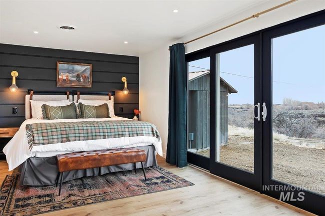 Bedroom featuring french doors, wood finished floors, and recessed lighting | Image 39