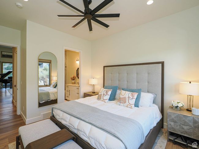 Bedroom featuring wood finished floors, recessed lighting, ensuite bath, and ceiling fan | Image 61