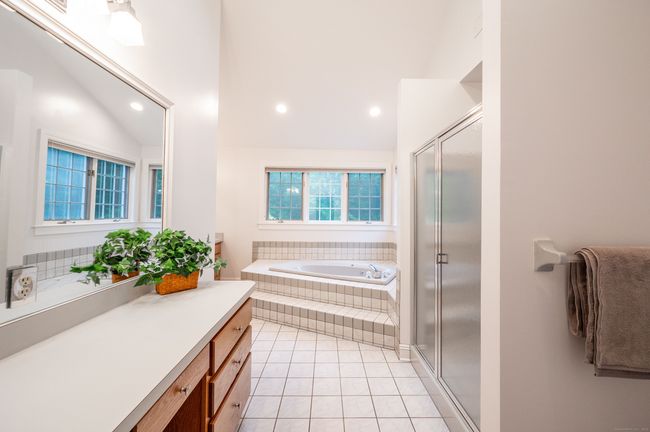 Ensuite Bathroom with jacuzzi tub, makeup counter, walk-in shower and double sink vanity | Image 30