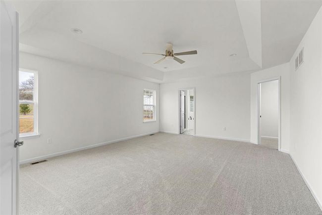 Carpeted spare room with ceiling fan and a healthy amount of sunlight | Image 8