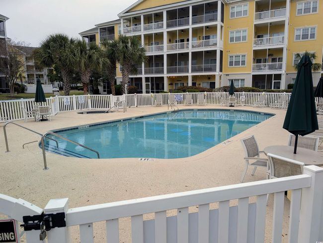 Community pool featuring fence and a patio area | Image 19