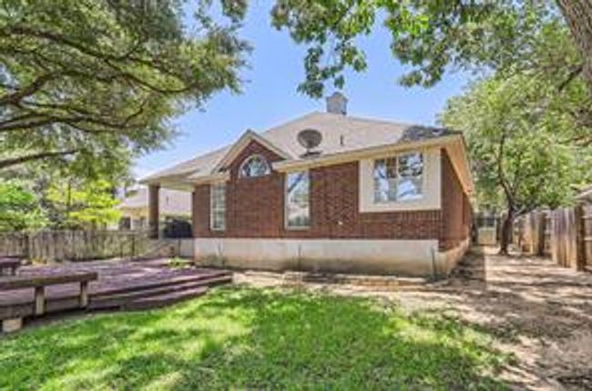 Rear view of house with a fenced backyard | Image 27
